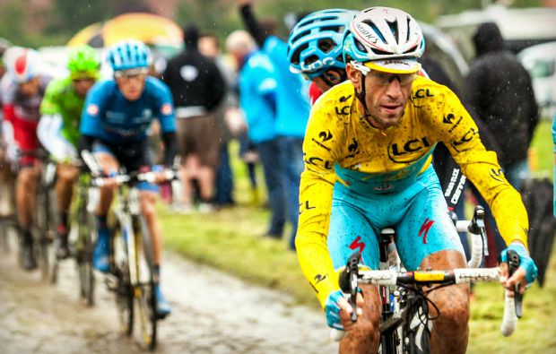 Ennevelin, France - July 09,2014: The Italian cyclist Vincenzo Nibali ( Team Astana) wearin the Yellow Jersey on a dirty cobbled road during the stage 5 of Le Tour de France 2014. Nibali won this edition of competition.